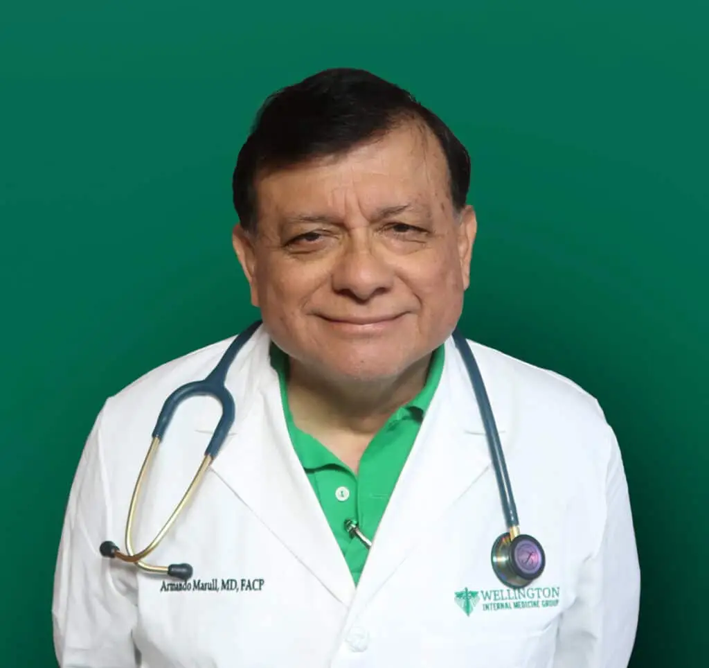 Friendly doctor in white lab coat with stethoscope on green background