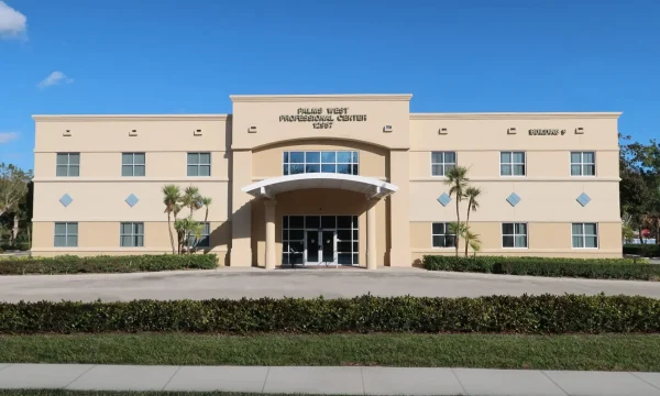 Modern internal medicine clinic with arched entrance and landscaped exterior